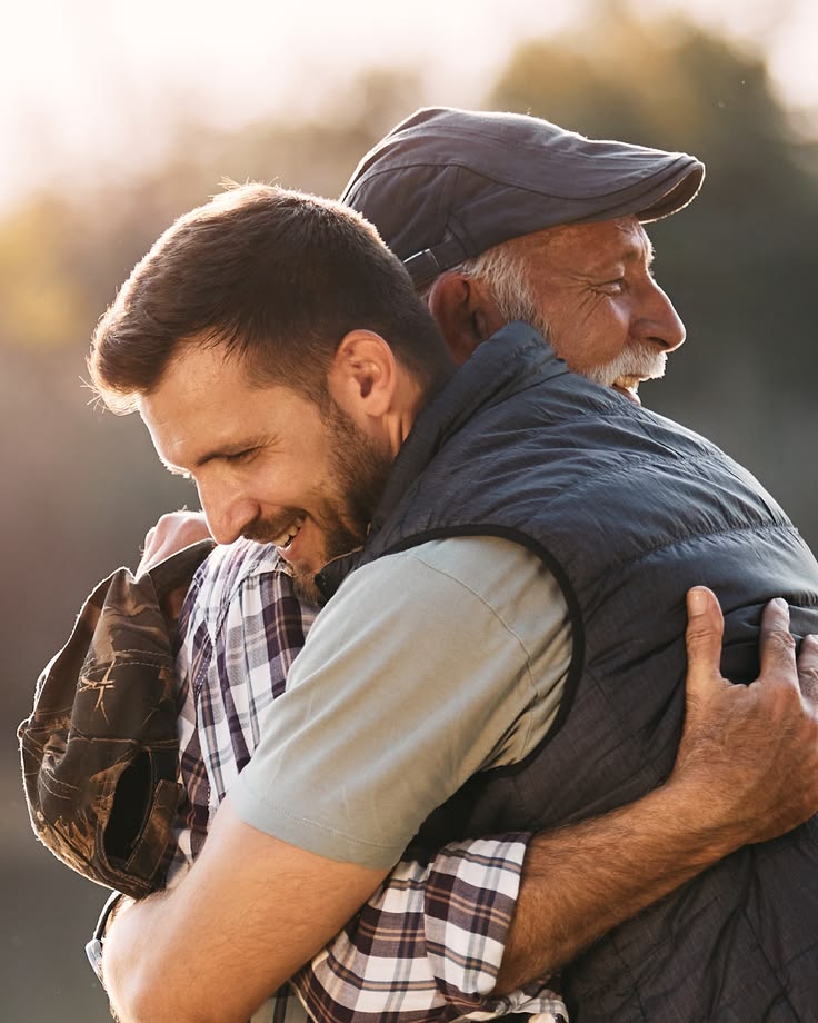 A father and son share a warm embrace.