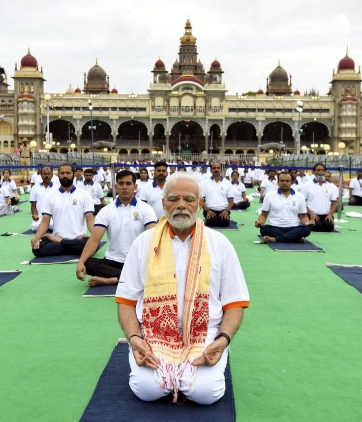 Prime Minister Narendra Modi performing yoga with a large group of people
