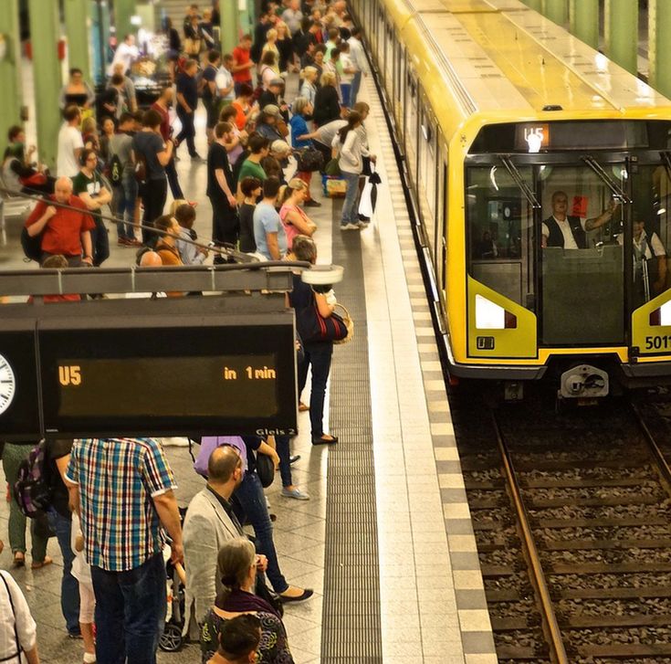 people waiting on platform to board a metro
