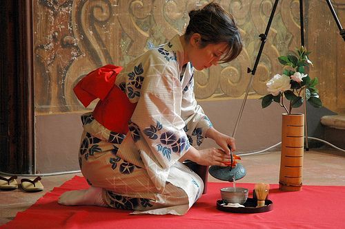 Japanese woman pouring tea in a cup