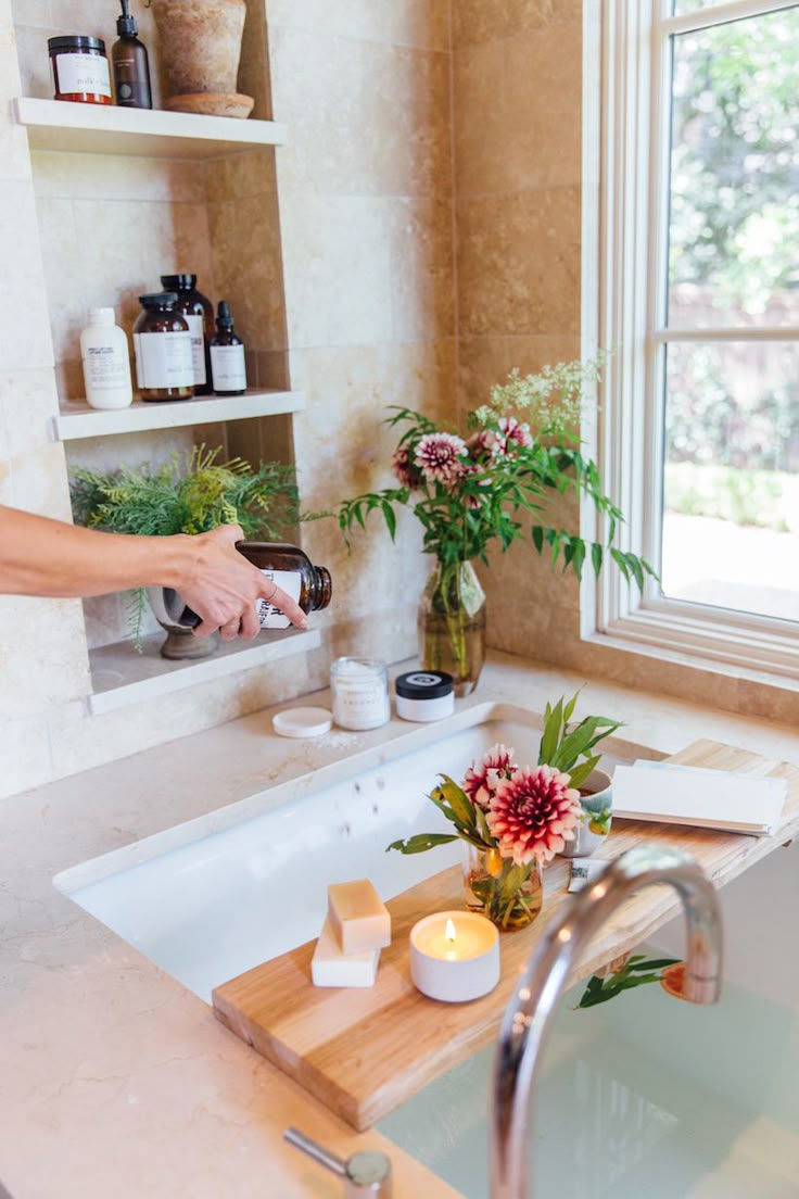 a person pouring a liquid into a bath tub