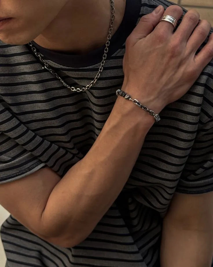 simple chain and ring worn over a striped T-shirt