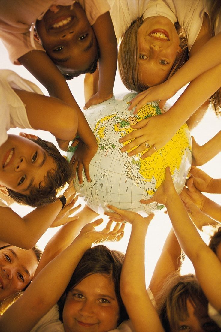 kids holding a figure of Earth